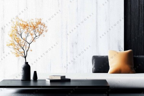 "Minimalist photo of a black vase with orange leaves on a modern coffee table."