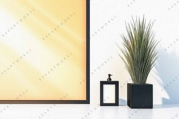 Minimalist photo of potted plant and framed artwork against a white wall.